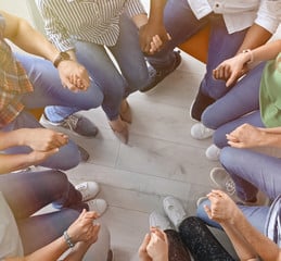 group holding hands in a trust exercise