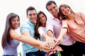 Casual group of people with hands together in the center - teamwork concepts