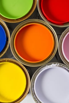 Paint cans on different colors - isolated over white