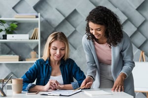 adult-female-coworkers-discussing-work-project