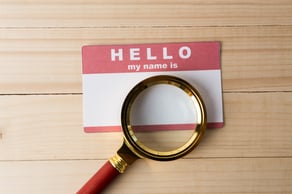blank-name-tag-with-magnifier-glass