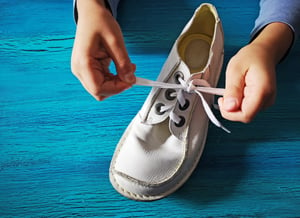 boy-is-learning-how-tie-shoelaces-close-up-hands-shoe