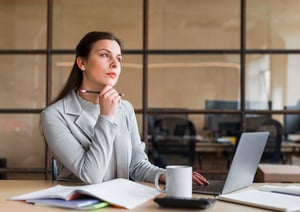 contemplating-businesswoman-sitting-front-laptop-office-1