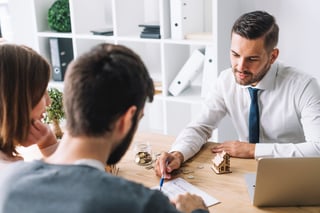 couple-consulting-with-real-estate-agent