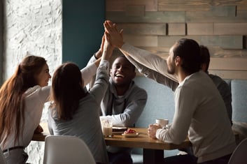 diverse-excited-best-friends-giving-high-five-together-cafe-meeting