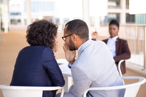 employees-gossiping-about-young-female-colleague