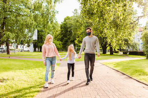 family-members-walking-park-wearing-fabric-face-masks