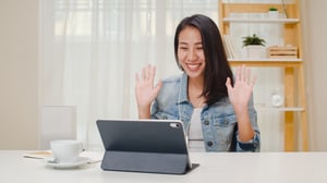 freelance-business-women-casual-wear-using-tablet-working-call-video-conference-with-customer-in-workplace-in-living-room-at-home-happy-young-asian-girl-relax-sitting-on-desk-do-job-in-internet