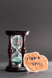 hour-glass-with-time-s-up-text-black-surface