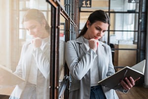 serious-young-woman-looking-diary-office-1