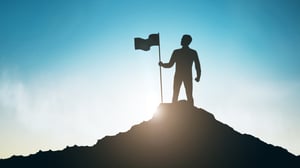 silhouette-man-with-flag-mountain-top-sky