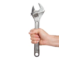 someone-s-hand-holding-spanner