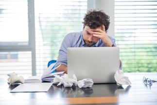 stressed-man-with-laptop-office