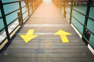 two-way-yellow-traffic-arrows-sign-pointing-two-direction-wooden-bridge