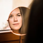 woman-looking-her-face-mirror-1