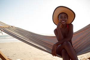 young-woman-relaxing-hammock-beach