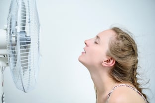 young-woman-sitting-fan-with-closed-eyes-from-pleasure-summer-heat