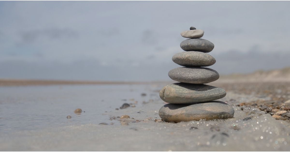 stack of smooth flat rocks on a beach