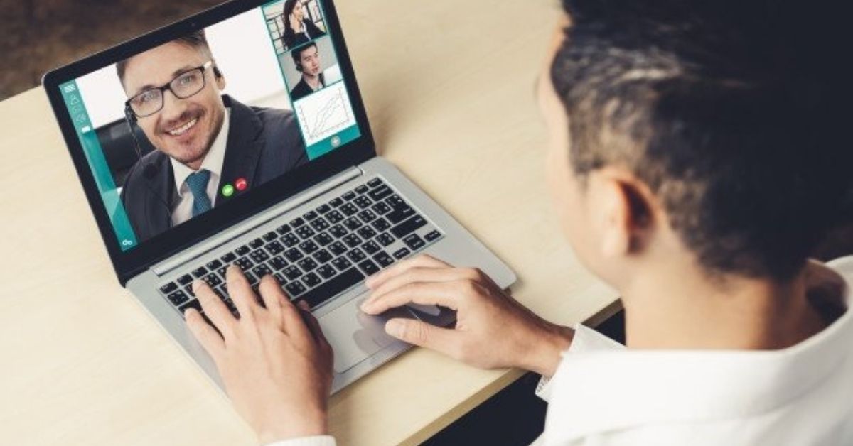 person sitting at desk on a virtual meeting