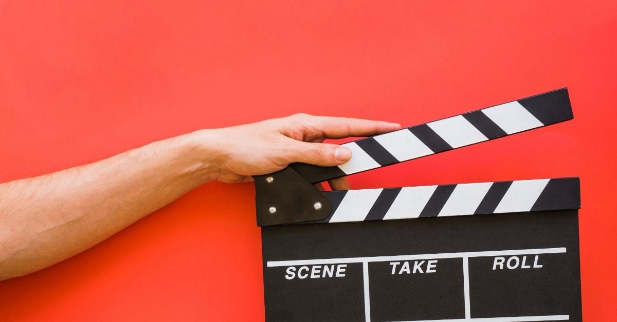 movie clapper in front of a red background