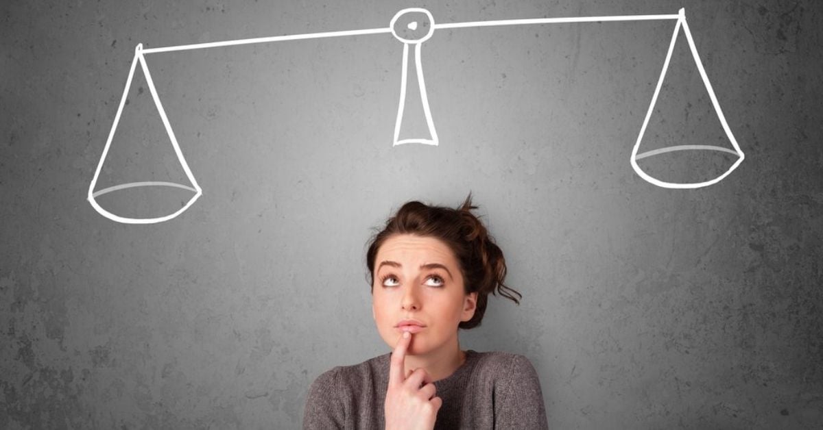 Young lady taking a decision with scale above her head