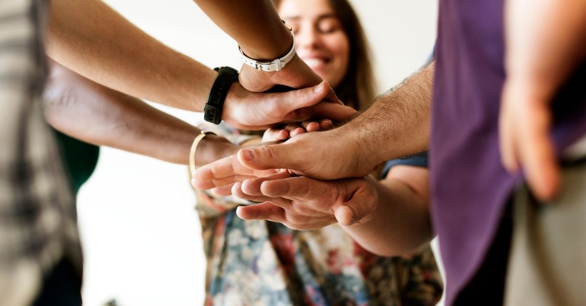 group stacking hands in the middle of their circle