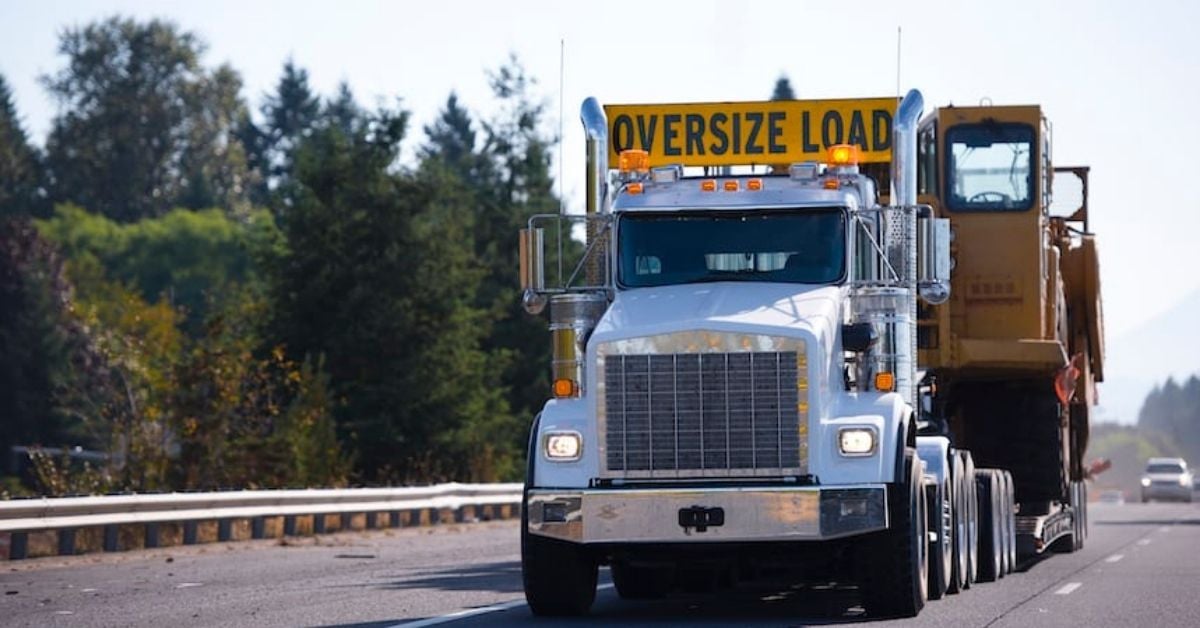 Oversized load pickup truck driving down a winding back country road