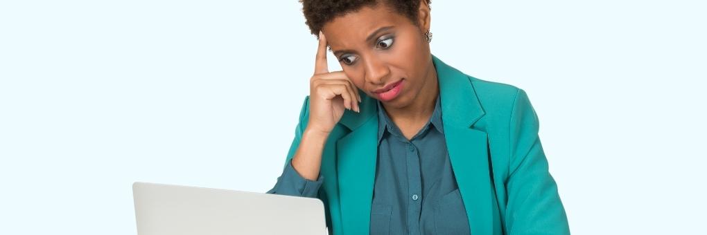 Woman looking at computer in disgust, frustrated