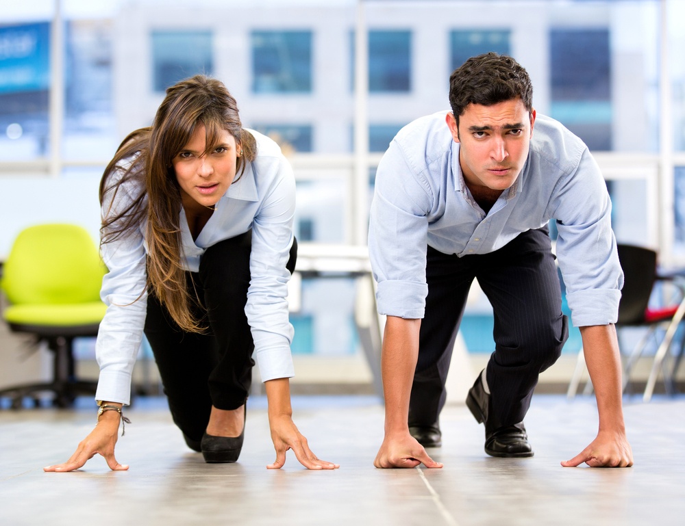 Competitive business couple racing at the office