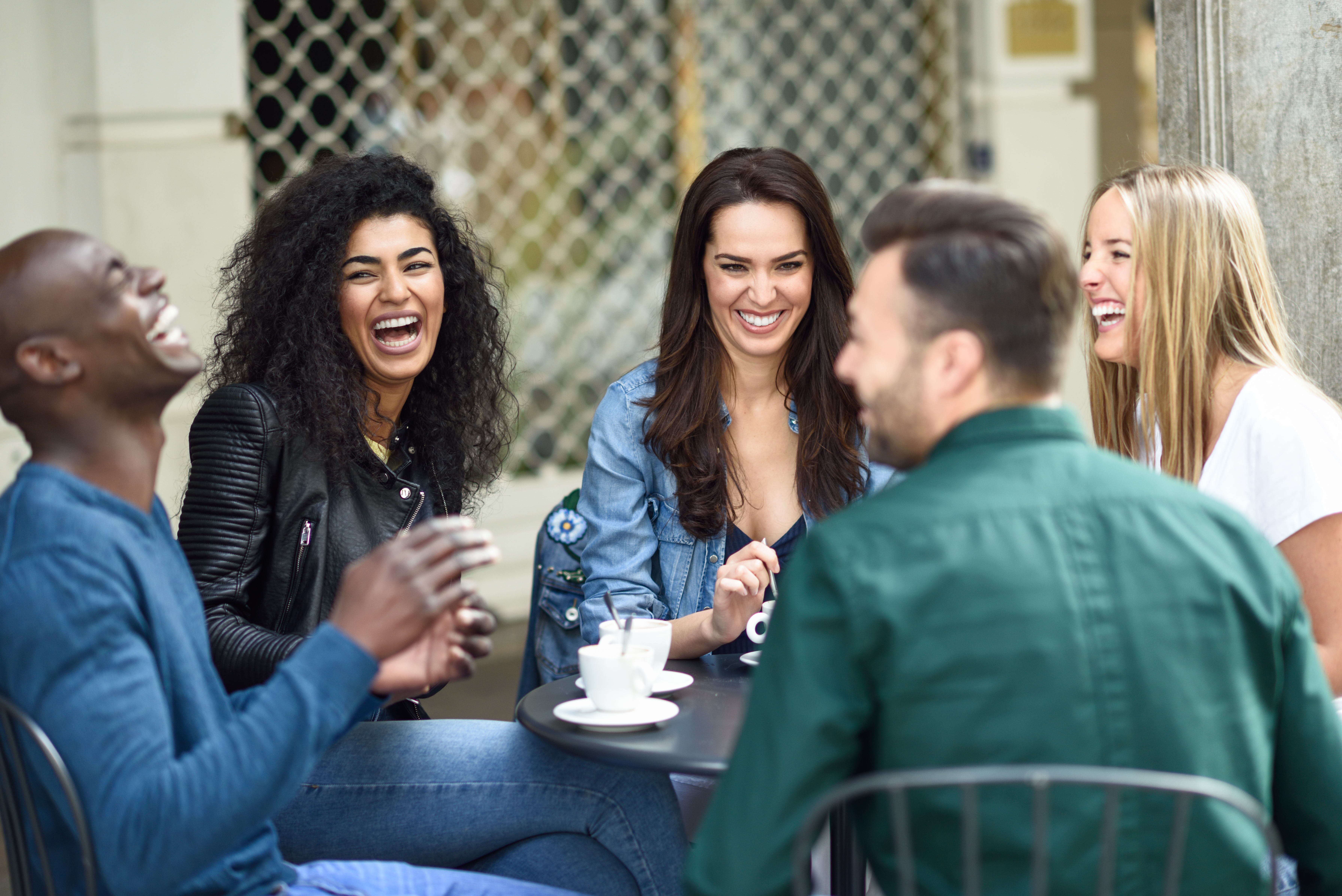 group laughing over coffee