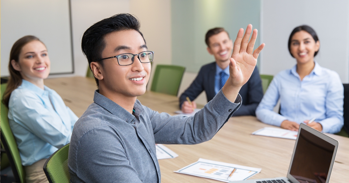 one employee raising their hand in a meeting